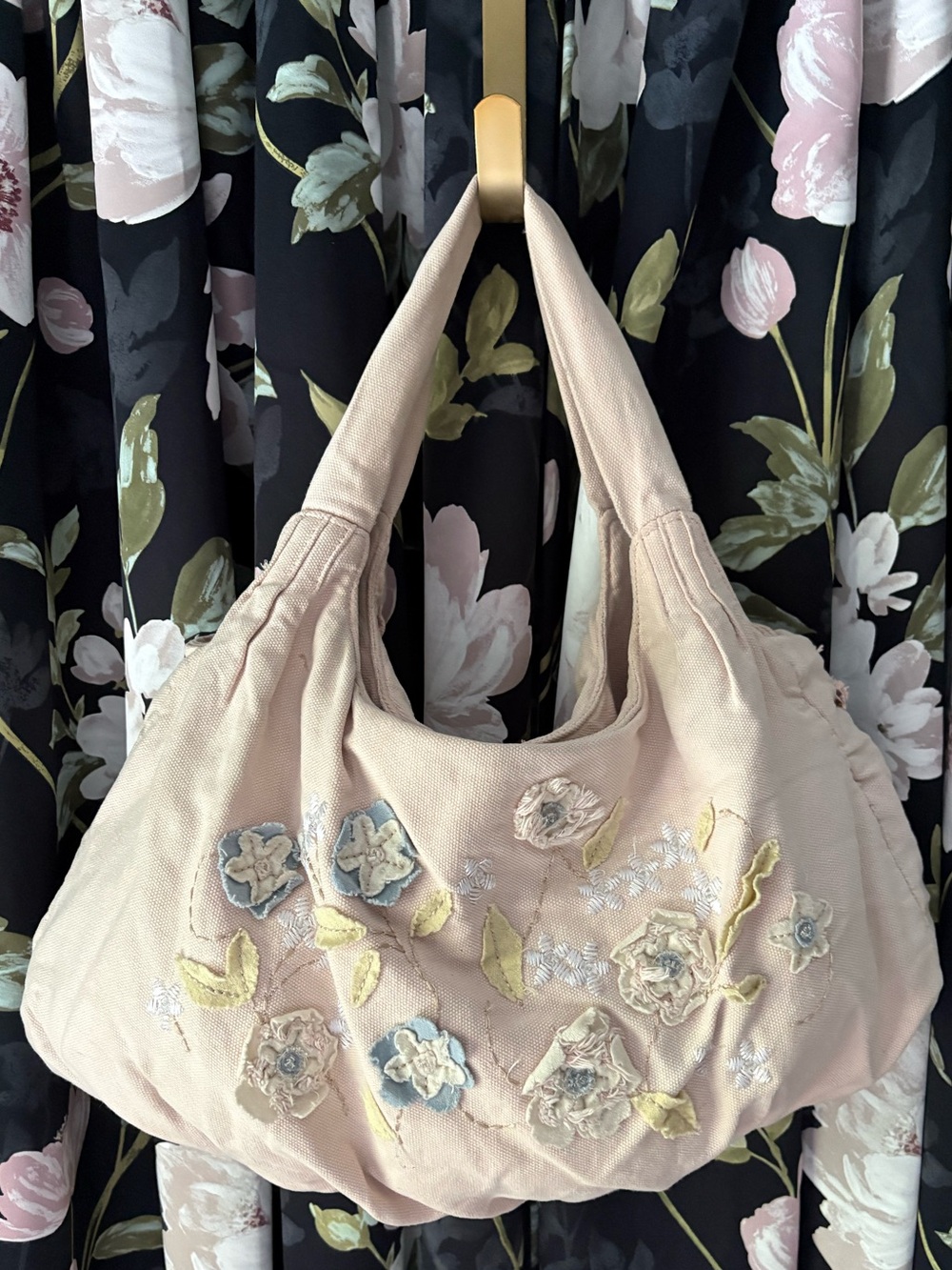 This is a Kenzie slouchy hobo bag 
pink fabric,blue and cream floral embroidery